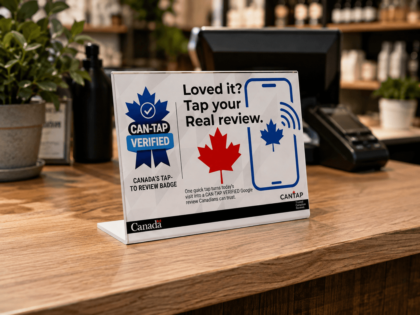 CAN-TAP VERIFIED tap-to-review sign beside a retail checkout and payment terminal in Niagara Region, Ontario.